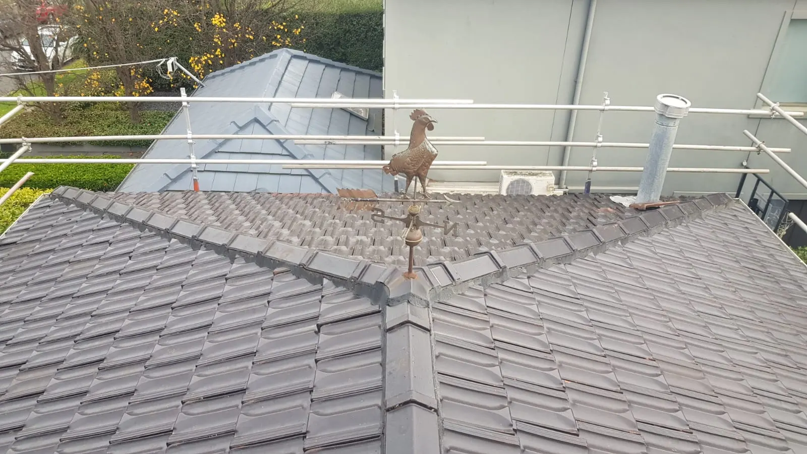 Finished charcoal tiled roof with ridge capping and roof penetrations
